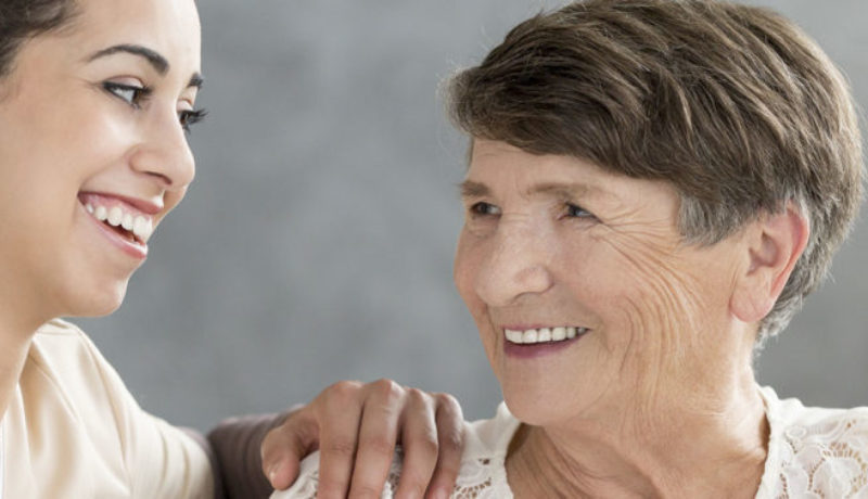 Nurse and woman discussing activities at her assisted living facility.