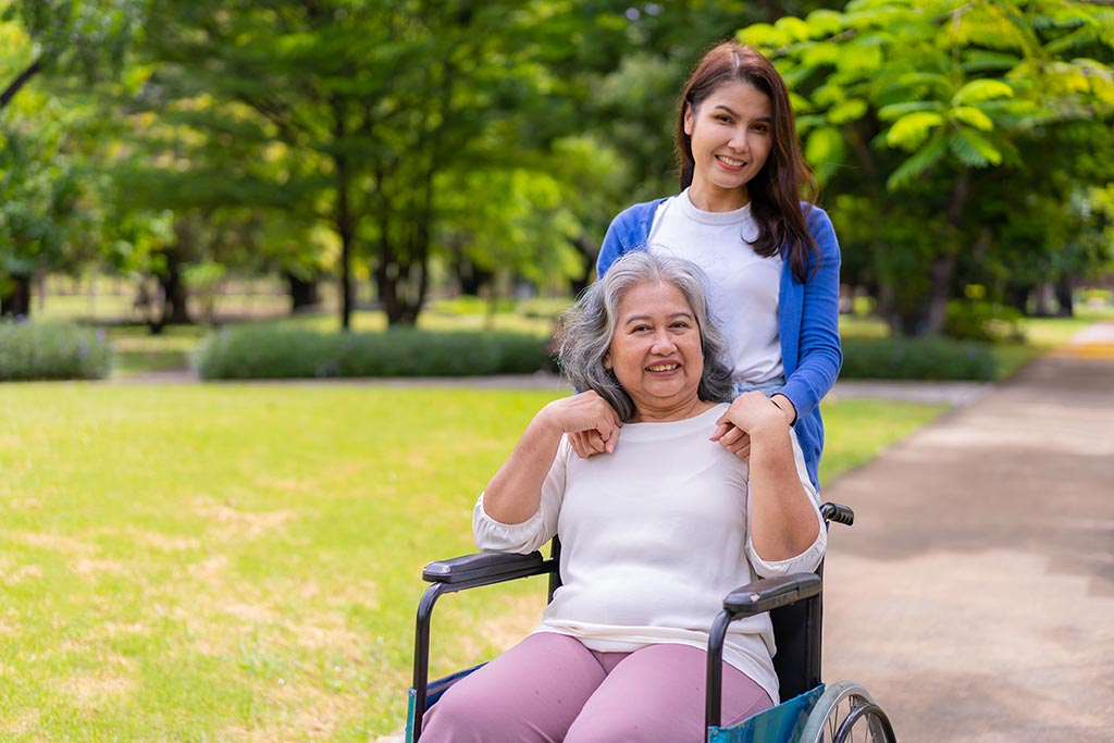 Senior Chronic Wound Care Nurse and Patient in Wheelchair