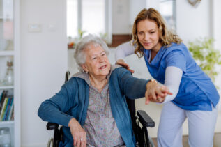 Skilled Nursing Employee Helping Senior Patient